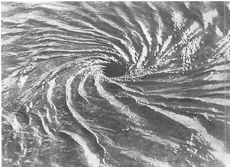 A whirlpool in ocean water: the center is not an element: it forms within the wholeness.