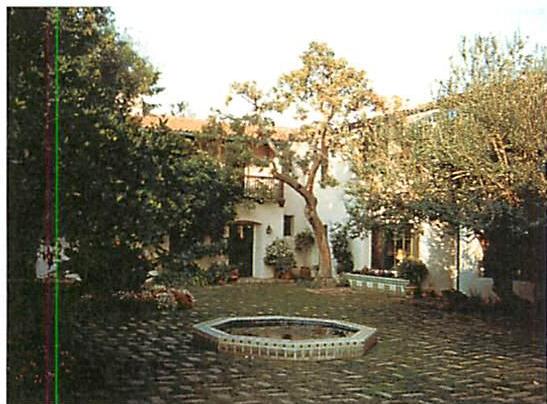 An old Pasadena courtyard that opens naturally off the street, preserving its wholeness and its harmony (Left). Pasadena street, the structure of its wholeness destroyed by a condominium over parking garages. This condominium, with parking underneath and rooms above, destroys the structure of the street, and spoils the neighborhood. The structure-destroying transformation is not merely bad design. It destroys the wholeness that is there. Serious damage is caused to the street, and to the neighborhood.