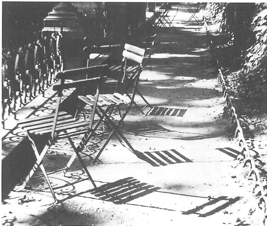 Luxembourg Garden, Paris, 1949. Chairs, tables, shade, sunlight, a railing, the water. The peaceful leaves drift, preserving the structure of this Paris garden, and creating an unfolding in the modern world.