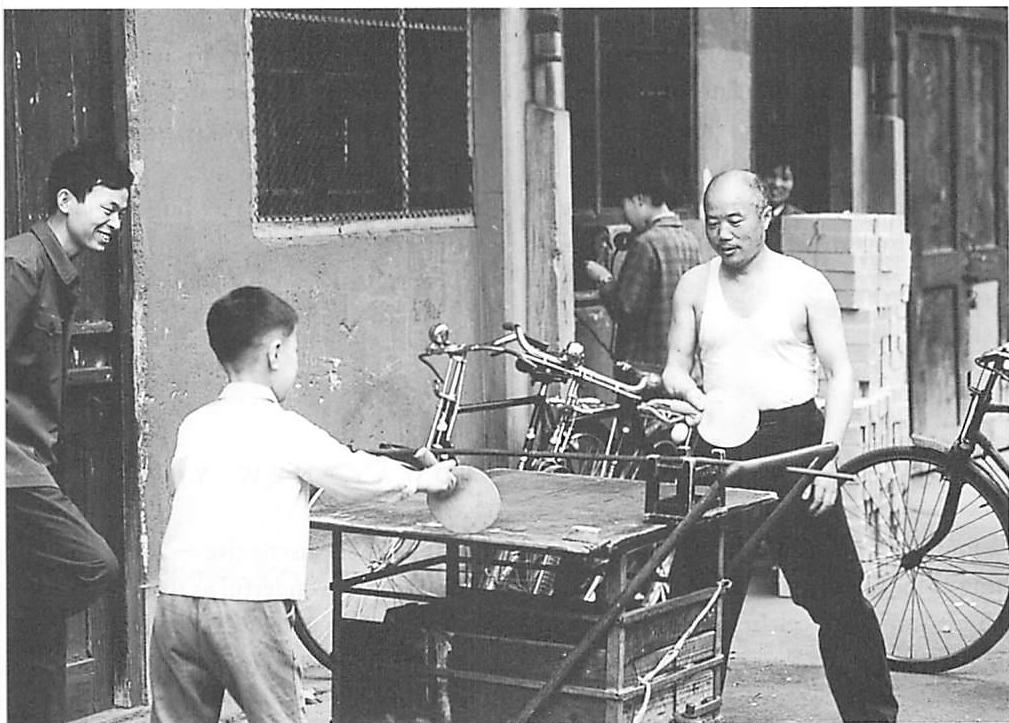 An old man and a boy playing ping-pong on the sidewalk in Shanghai. How unerringly they place the table: they don't care who is coming, what they care about is putting the table where they can have a good game. And it is this blissful unconsciousness which makes the structure-preserving quality of their table, and their game, so accurate.