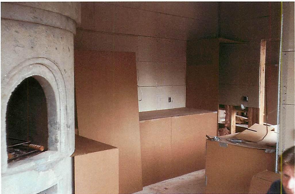 The kitchen mocked up in its entirety in cardboard, so we could see just how to make the kitchen fireplace. The idea of a cylinder had already occurred to me from seeing the room shape and recognizing its two lines of sight. Now we had to make the cylinder work, and to do that we had to have the full three-dimensional configuration, as it was going to be. We had to make many many versions before it all sat right.