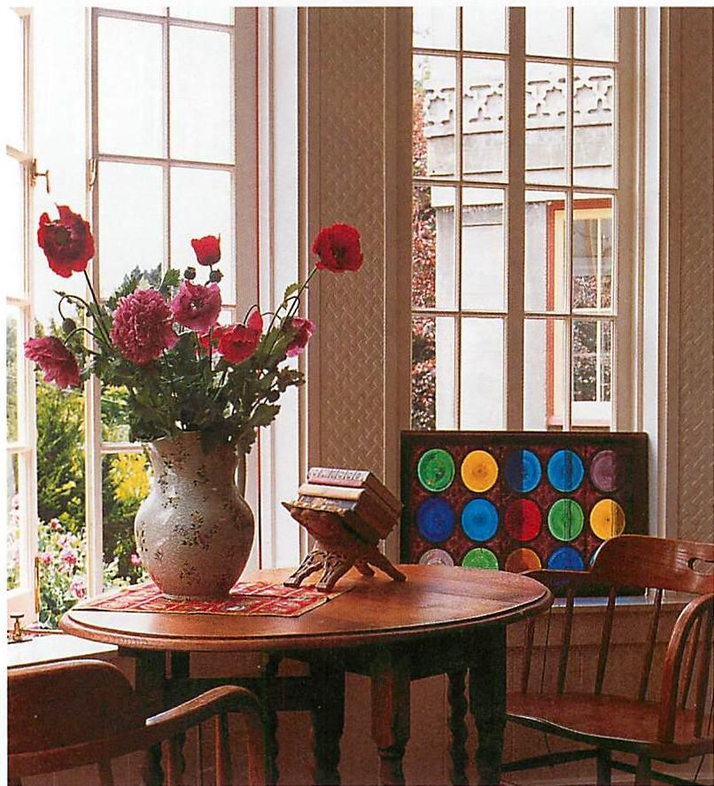 On the living room table: a vase of flowers from the garden