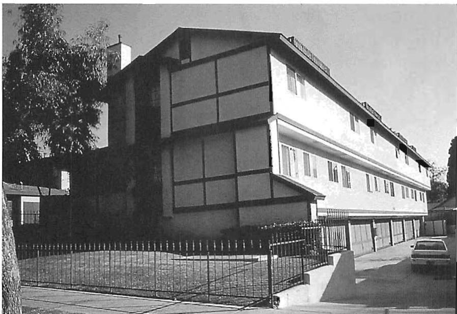 NOT BELONGING: A conventional motel in Pasadena, California. This horror is not exceptional, it is not especially ugly. In 1985, it was simply the norm. Here the greed of the developer, building for no reason except to make money, and depriving the inhabitants of every comfort of their own humanity, holds sway. The tired and towlry building condemns its inhabitants to a life of almost nothing.