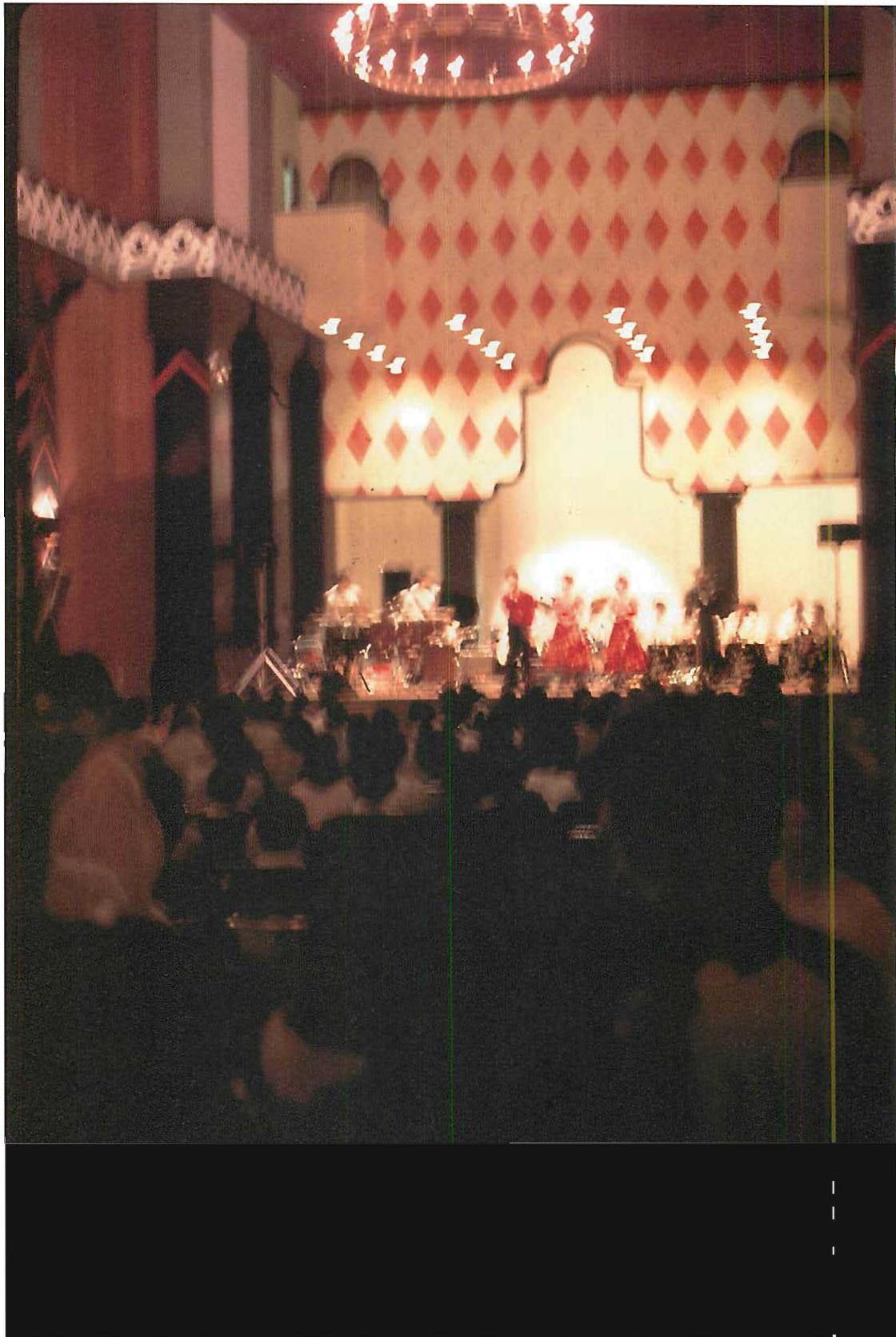 Concert in progress in the Great Hall at Eisbia. The stage is a living center, the lights are living centers, the diamonds and ornaments are living centers. Second state of completion, 1989. The photograph is blurred because, to get it at all, I had to use a hand-held one-second time exposure.