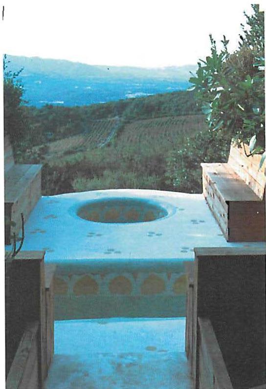 Hot and cold tubs overlooking vineyards of the California hills, hand-ground colored marble dust. Sonoma, California. Christopher Alexander, Eleni Coronavli and Mark Briner. 1985