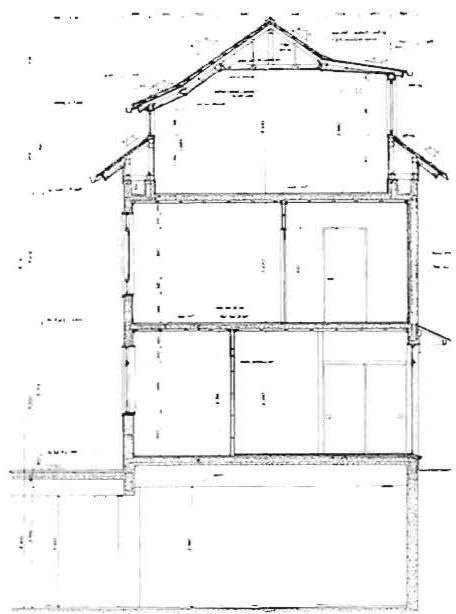 Cross section of one two-and-a-half story house showing three apartments, one in the roof space. Underground parking has retaining walls and columns in the structural positions of the house bearing walls.