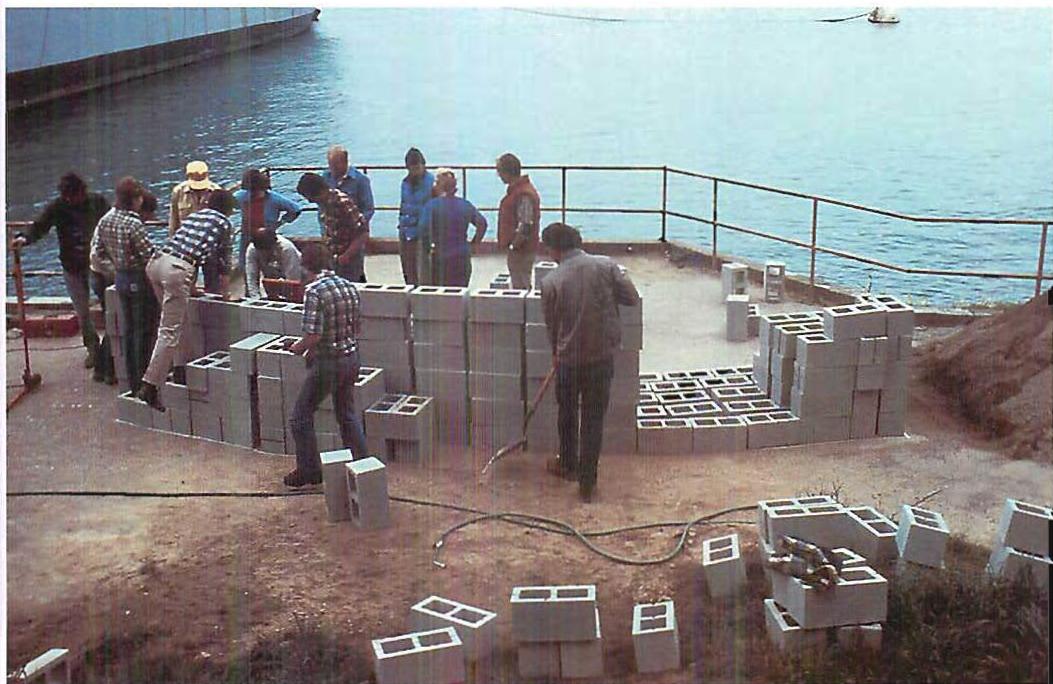 Fort Mason Bench. San Francisco. Placing dry-stocked concrete blocks to get the right arrangement of the bench. Christopher Alexander and students, 1988.
