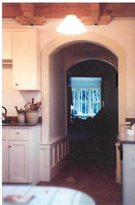 Looking from the kitchen through the living room, to the windows of the library at the far end of the house.