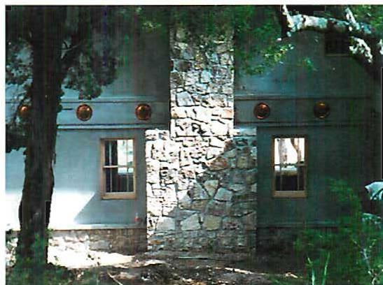 Back of the Heisey house, showing the copper medallions on the wall and the back of the stone fireplace.