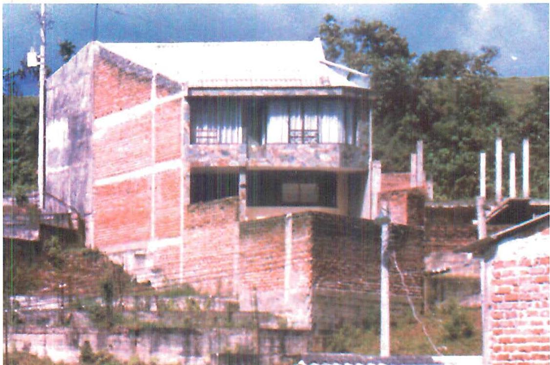 A large house among the low-cost houses.