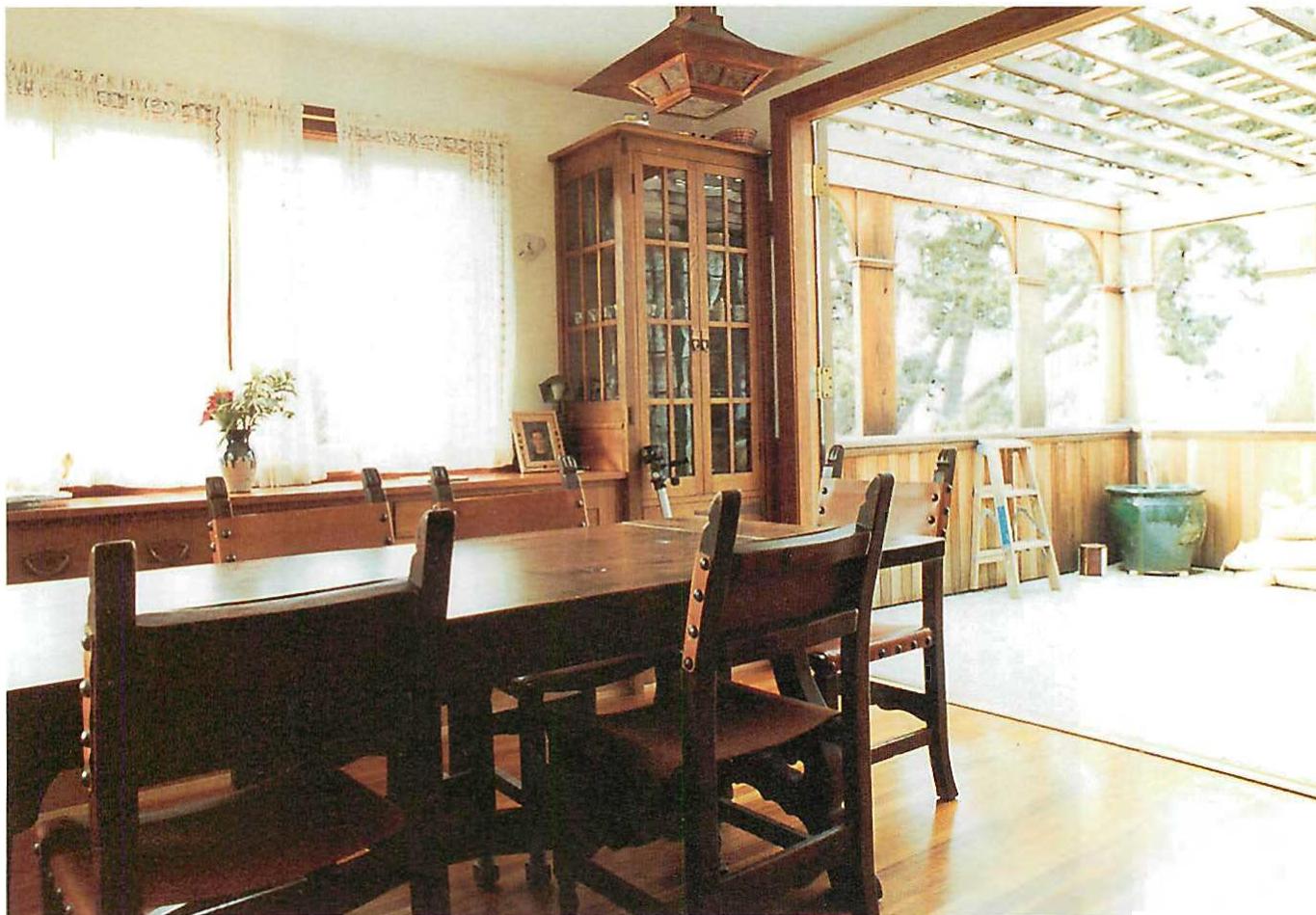 The dining room of the Sullivan house, opening onto an outdoor terrace. Here the main centers include the generous table, the wide opening to the terrace, the outdoor terrace itself, the two vertical cabinets at the corners of the room. (only one visible) and the overhead trellis on the terrace. Christopher Alexander and David Soffa, 1992.