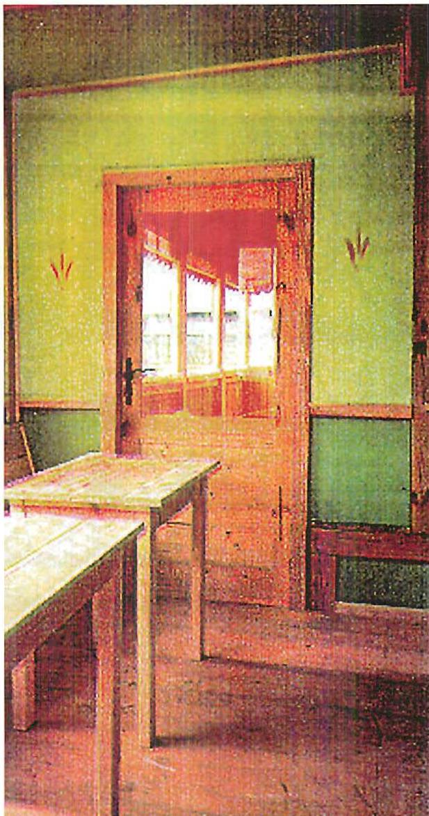 Upstairs interior of the Linz Cafe, Christopher Alexander, 1980. Sparse, nothing but plain tables, a perfect green, utter simplicity of rectangles in the wall and door.