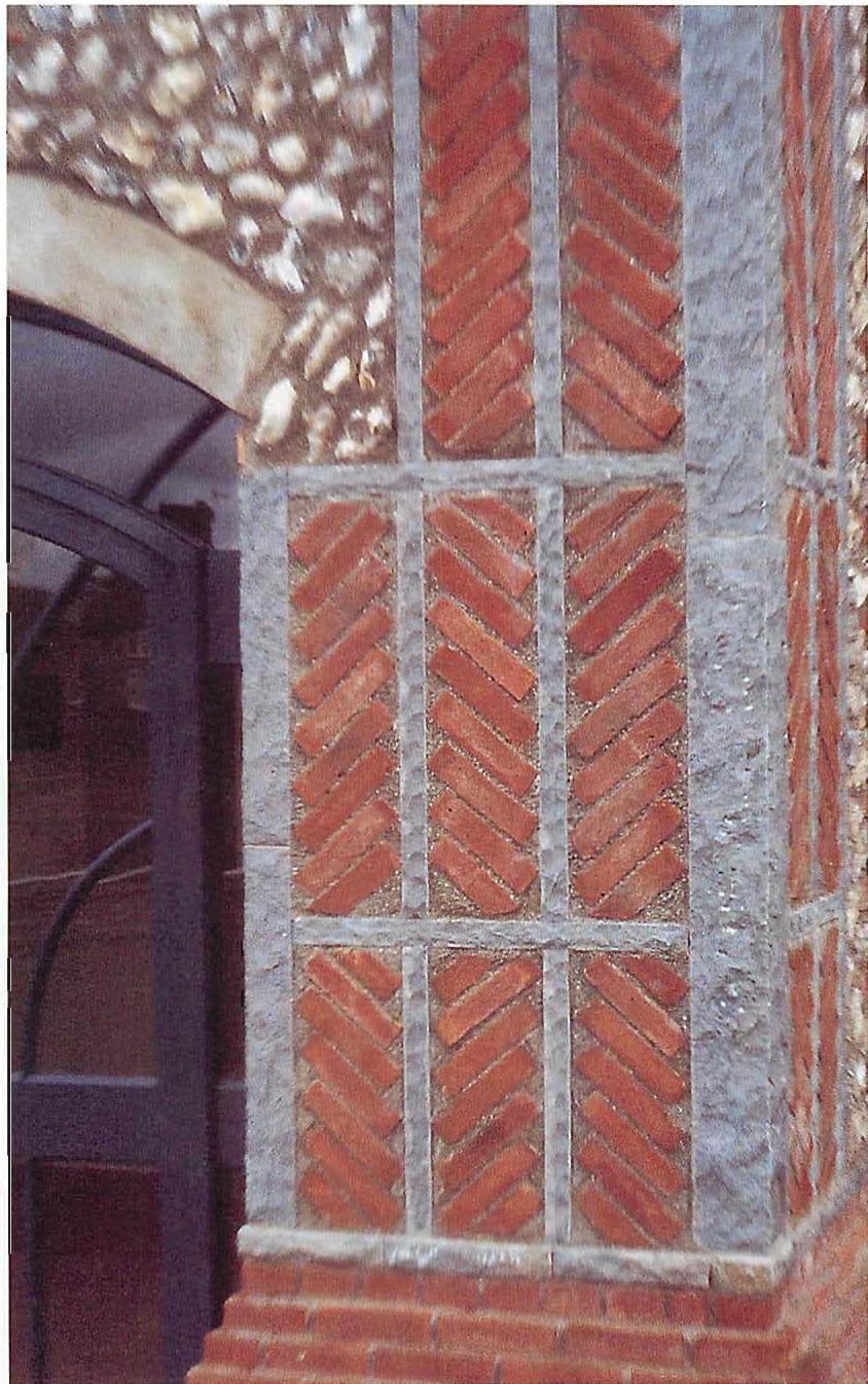Stone and brickwork on the entrance porch of West Dean: the stones are cut in thin lines, and together with the panels and herringbone bricks, have been chosen to make the porch wall of STRONG CENTERS with GRADIENTS, ALTERNATING REPETITION, STRONG CENTERS, LOCAL SYMMETRIES, CONTRAST.
