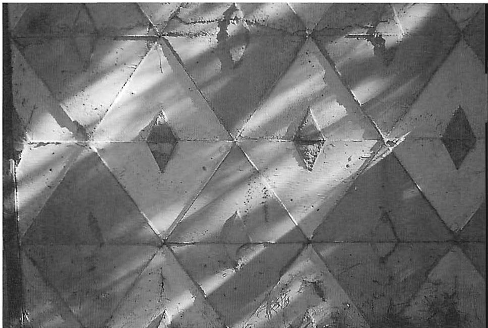 Ornamented concrete wall panel, cast, with layers of diamonds cast into the panel in the vertical position. Christopher Alexander, 1986.