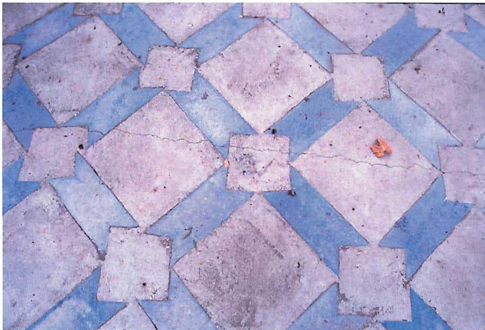 Ornamented concrete slab in the Fresno Farmer's Market, made by pressating 1/2 inch thick light blue fishtails, then dropping them into the slab while the slab was wet and still being worked, floated and traveled. Christopher Alexander et al., 1984.