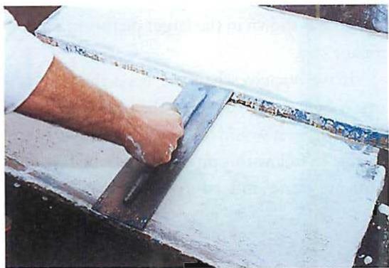 Troweling in the white terrazzo after the blue has hardened