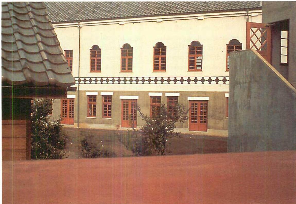 Completed college building, showing these windows as they finally appeared in place.
