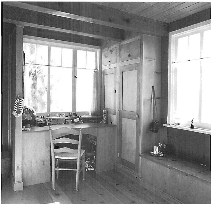 Sala house interior with wooden paneling, built-in bench and counter.