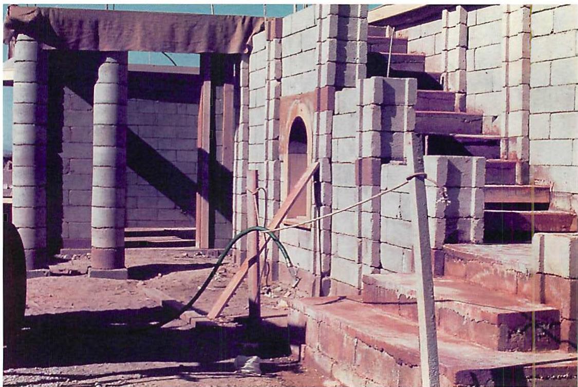 Dry stacked blockwork when walls are almost complete and have had some cells filled.