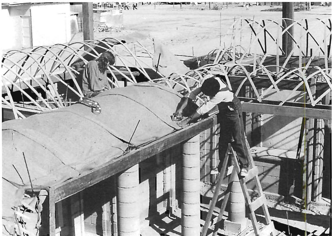 Stapling the burlap over the woven baskets once the baskets are complete.