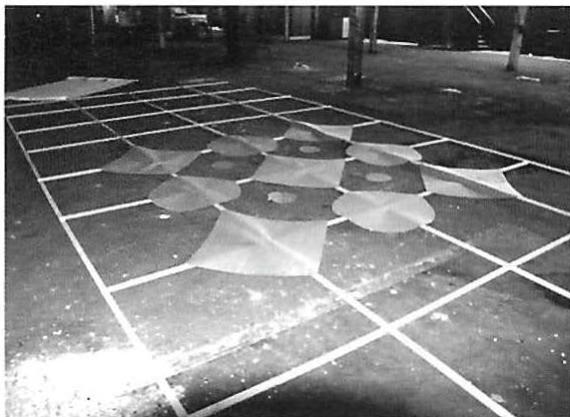 A mockup in our warehouse. This design, one of many, was first inspired by sketches like the one on page 570. However, it was not designed or calculated in advance but rather worked out by tearing and cutting pieces of paper, at full size, in response to what looked good on the warehouse floor. In particular, it was motivated by the search for what designs and arrangements seemed to create a profound relationship between a person standing there and the place.