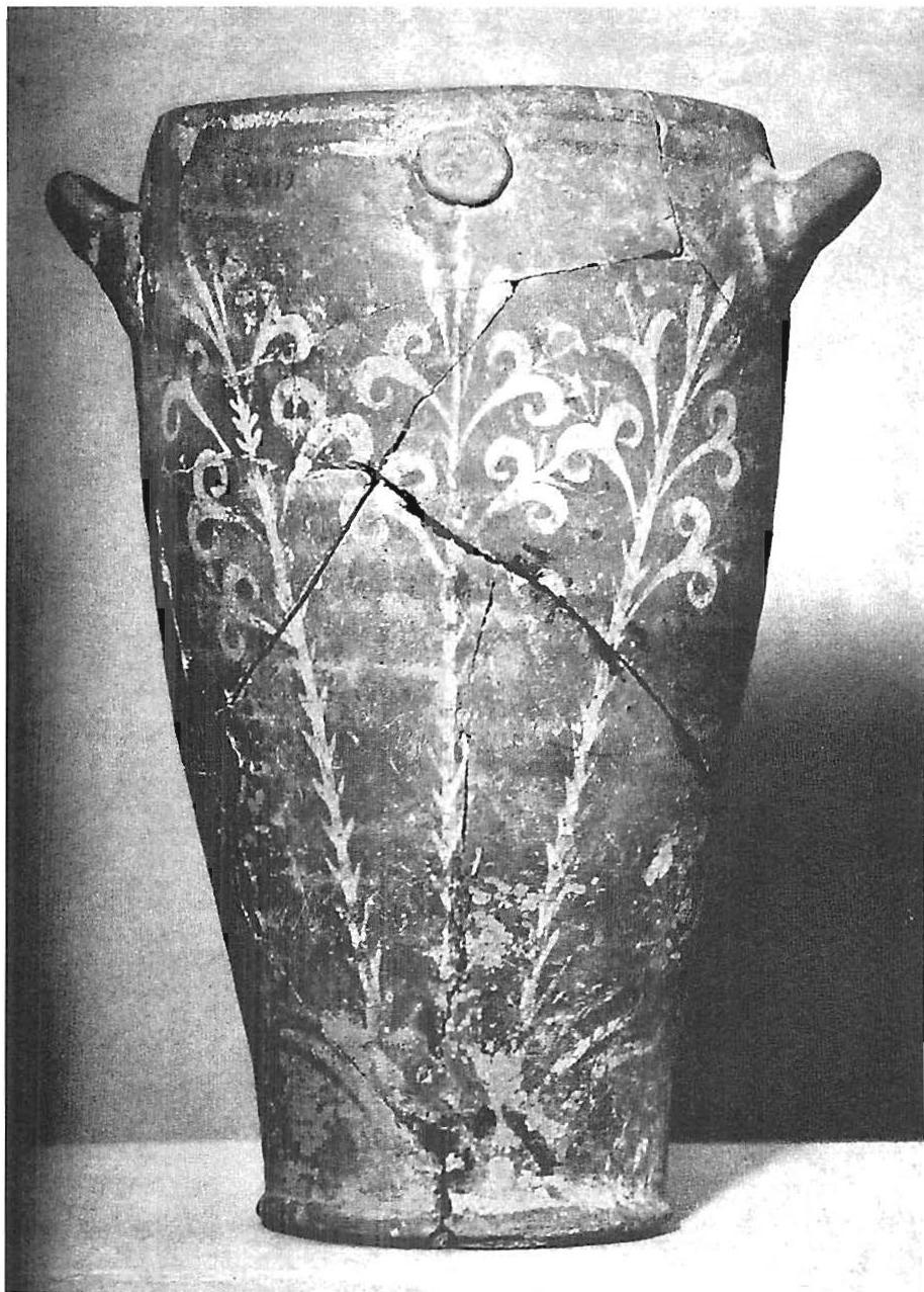 Mycenean vase with hand-drawn lilies painted on it. Each lily flower, stem, leaf is shaped, sized and placed on the surface so that each one fits its larger situation perfectly.