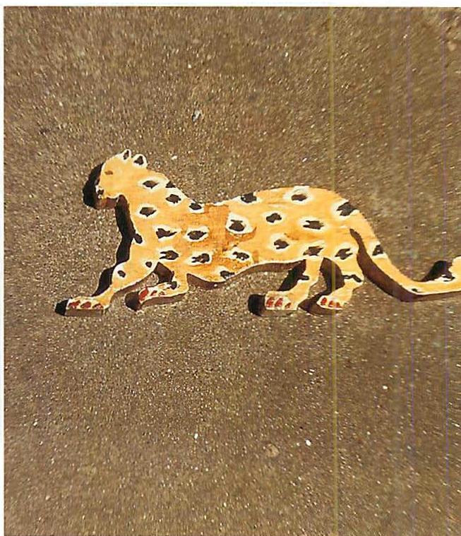 The cutout wooden leopard I made as a template for the mold from which we then made the clay leopards for the floor.