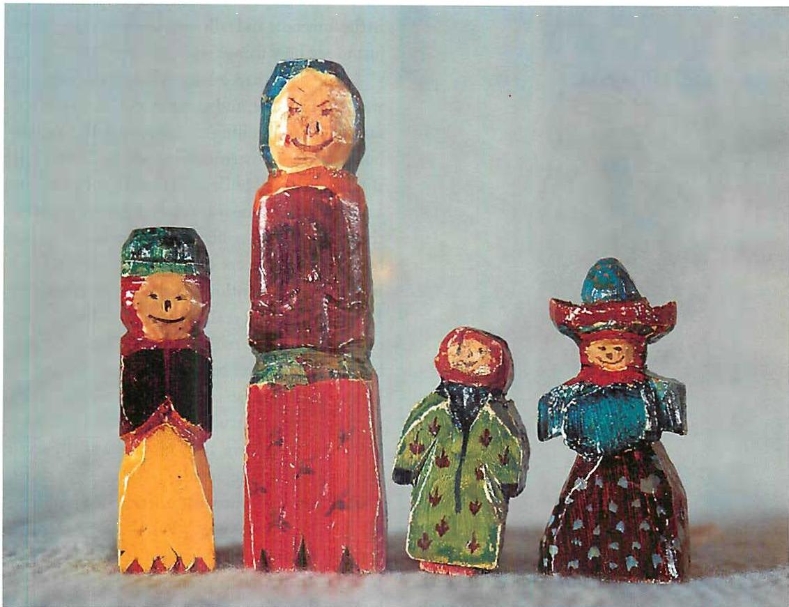 Hand-painted dolls I carved for my children and painted in gouache. The green doll is the tiny one, second from the right.