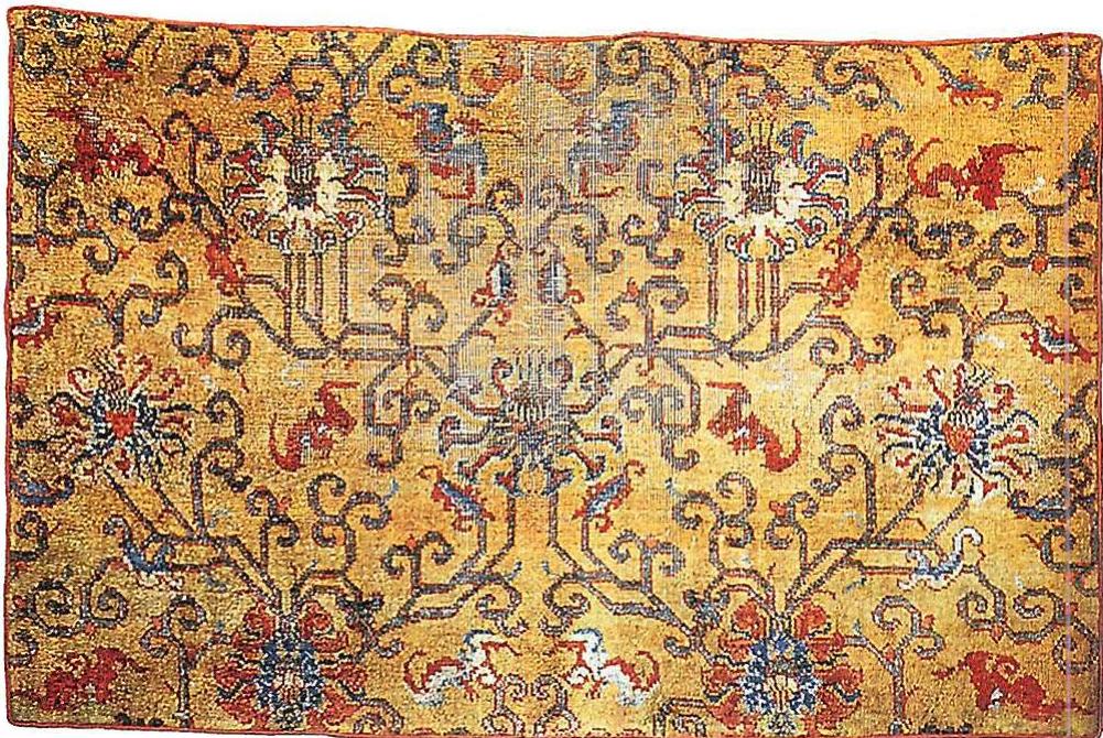 Fragment of a carpet from Turkestan with the subtle light of green and yellow and red